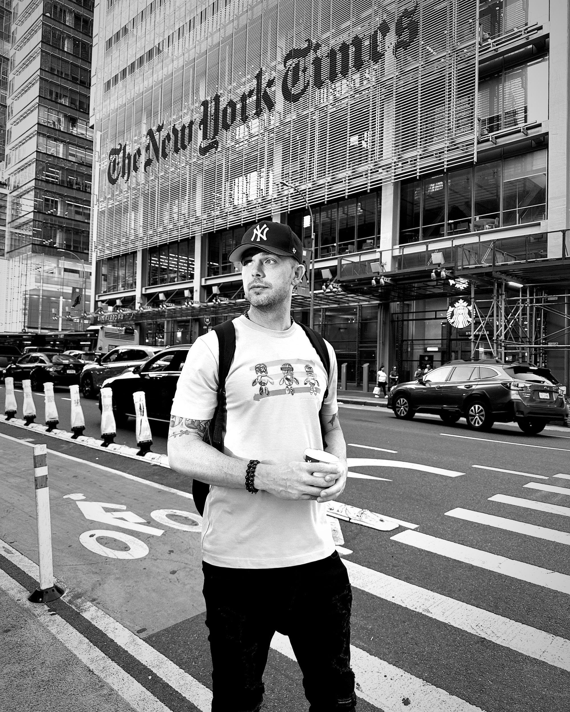 the founder mike powers wearing a skellow mellow XxX t shirt as he stands in front of the new york times